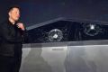 Tesla co-founder and CEO Elon Musk verbally reacts in front of the newly unveiled all-electric battery-powered Tesla Cybertruck with broken glass on windows following a demonstation that did not go as planned on November 21, 2019 at Tesla Design Center in