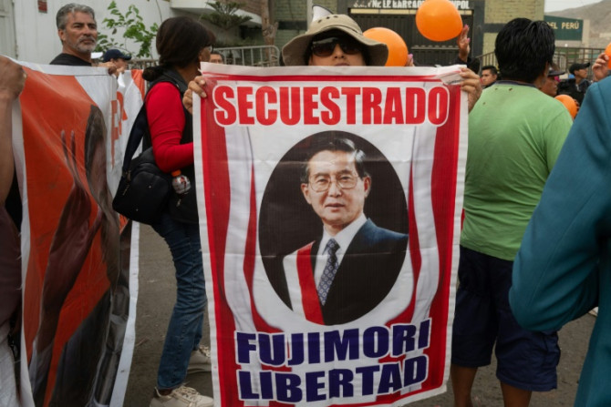 Supporters of former Peruvian president Alberto Fujimori gather at the entrance of Barbadillo prison to demand his release in the eastern outskirts of Lima on December 5, 2023