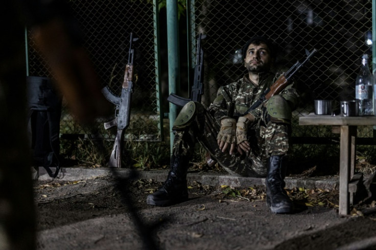 Civilians undergo a military training organised by the Armenian military school POGA at an outdoor tennis court on a street in Yerevan in October 2023