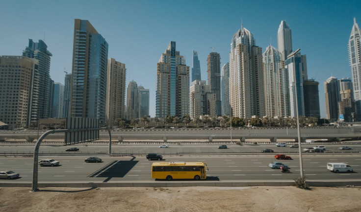 Yellow Bus on Road Near City Buildings. Representational Image.