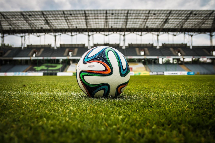 Multicolored Soccer Ball on Green Field. 