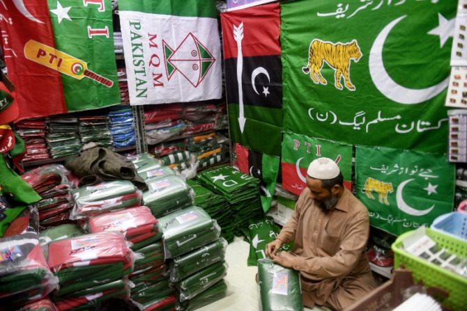 A shopkeeper in the Pakistan port city of Karachi arranges flags of political parties for sale ahead of next month's election
