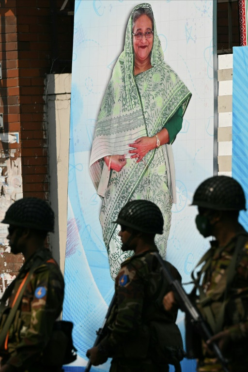 Soldiers stand in front of a portrait Prime Minister Sheikh Hasina in Dhaka on January 6: her government's intolerance towards dissent has given rise to resentment at home and expressions of concern from Washington and elsewhere abroad