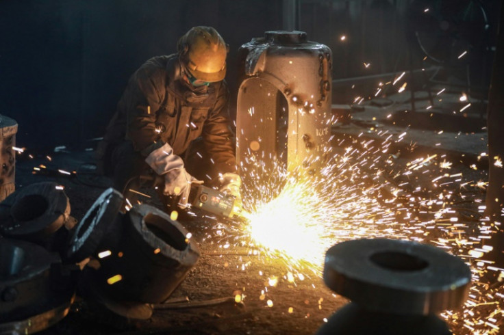 An employee works on steel casting at a factory in Hangzhou, in China's eastern Zhejiang province on January 17, 2024.