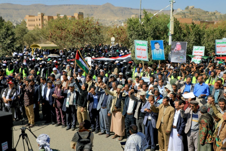 People wave Palestinian and Yemeni flags as they chant anti-Israel and anti-US slogans during a protest in solidarity with the Palestinian people in the Huthi-controlled capital Sanaa on January 17, 2024