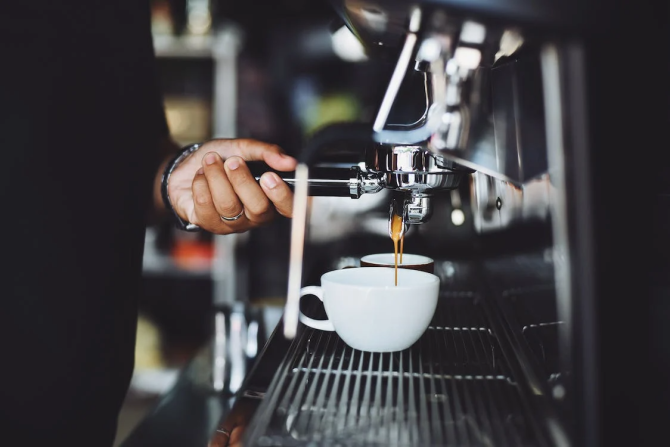 Close-up of Hand Holding Coffee Machine. Representational Image.