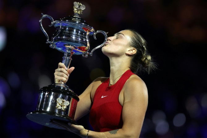 Aryna Sabalenka celebrates with the Daphne Akhurst Memorial Cup after defeating China's Zheng Qinwen in the Australian Open final