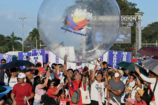 Thousands of flag-waving people massed at a seaside park in the capital Manila hours ahead of an early evening rally headlined by the president