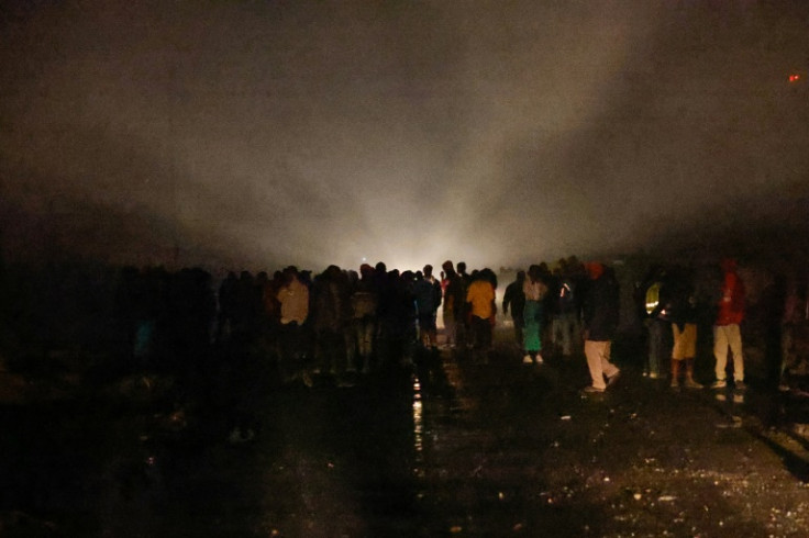 Residents look on after the huge explosion and fire in the Embakasi area of Nairobi