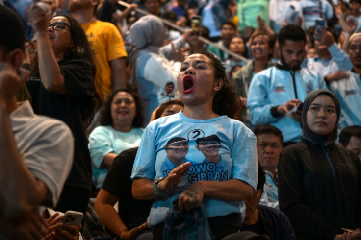 A supporter cheers as Prabowo Subianto addresses the crowd after claiming victory in the Indonesian presidential election