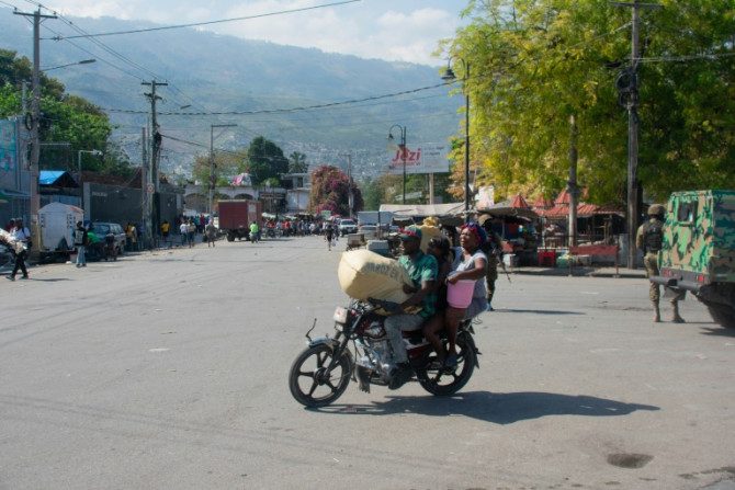 Residents leave their homes on March 9, 2024 as gang violence escalates in Port-au-Prince, Haiti
