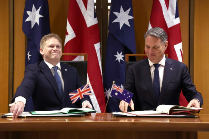 Australia's Deputy Prime Minister and Minister for Defence Richard Marles (R) and Britain's Secretary of State for Defence Grant Shapps take part in a signing ceremony at Parliament House in Canberra on March 21, 2024