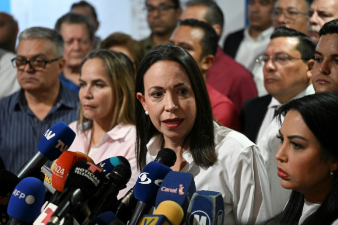 Two top aides of Venezuelan opposition leader Maria Corina Machado (C) have been arrested in the lead-up to the country's presidential election