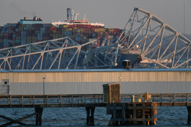 The steel frame of the Francis Scott Key Bridge sits on top of a container ship after the bridge collapsed in Baltimore, Maryland, on March 26, 2024