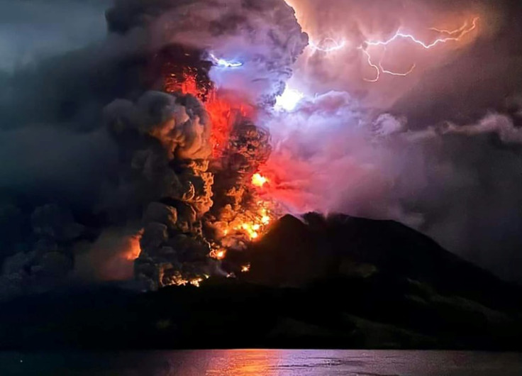 The crater of Mount Ruang flamed with lava against a backdrop of lightning bolts overnight after erupting five times