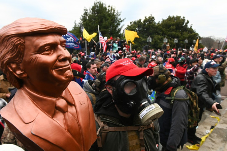 Donald Trump supporters, some wearing gas masks or riot gear, assembled on January 6, 2021, before besieging the US Capitol