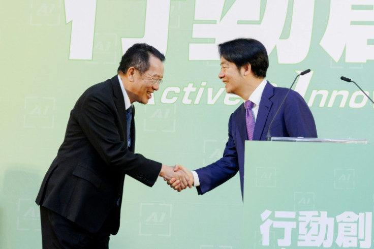 Taiwan president-elect Lai Ching-te (R) shakes hands with Wellington Koo, the island's next defence minister