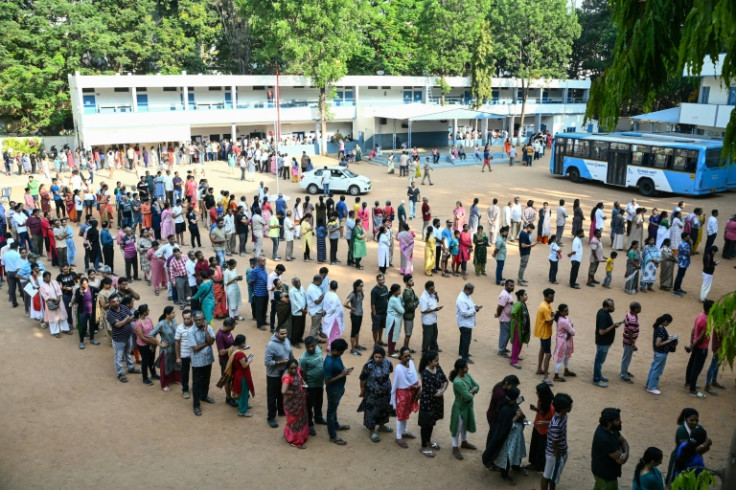 Voters brave the heat to cast their ballots at a polling station in Bengaluru