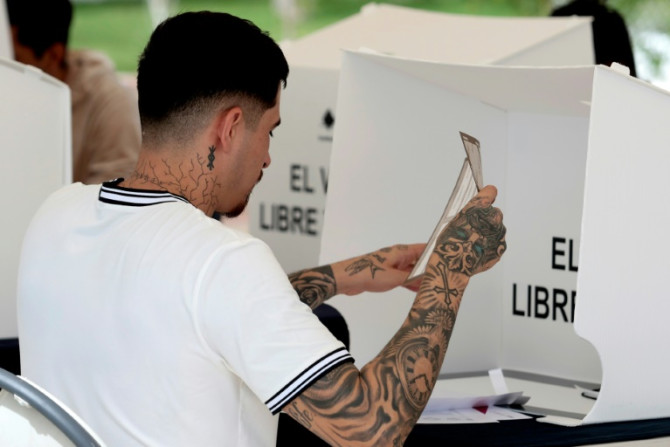 An inmate casts his early vote in Mexico's presidential election inside a prison in the western state of Jalisco