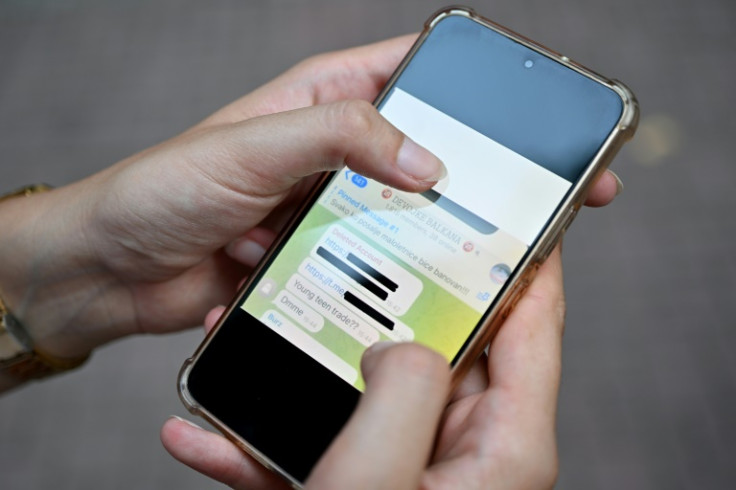 Legal expert Jelena Drndarski showing grabs from various Telegram groups on her mobile phone