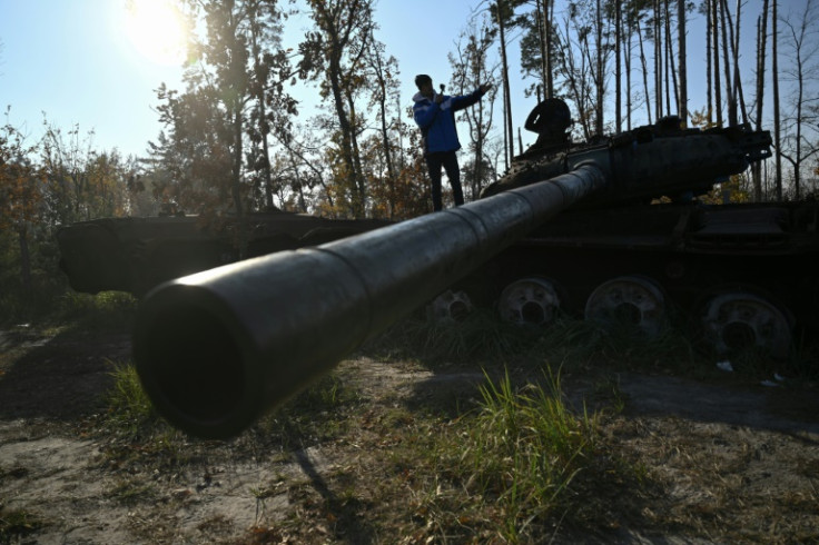 Spanish traveller Alberto Blasco Ventas visits a tank graveyard during a tour near Dmytrivka village outside Kyiv