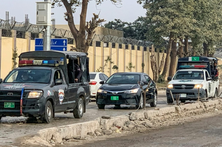 Police vehicles escort a car (C) carrying an accountability court judge as they arrive at the Adiala prison in Rawalpindi before the graft case hearing
