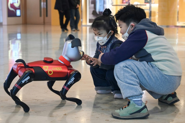 Cchildren palying with Weilan's AI pet dog BabyAlpha at a store in Nanjing, in China's eastern Jiangsu province Weilan's AI dog, called "BabyAlpha", sells for up to 26,000 yuan, and the company says 70 percent of buyers are families with young children.