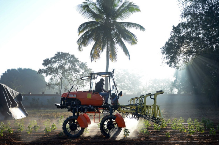 Workers at agritech startup Niqo Robotics, riding a tractor with AI-powered spot sprayer at a testing facility on the outskirts of Bengaluru