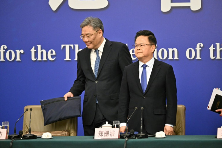 Zheng Shanjie (R), Chairman of National Development and Reform Commission of China, and Wang Wentao, China's Minister of Commerce, arrive to a press conference during the second session of the 14th National People's Congress (NPC) in Beijing on March 6, 2