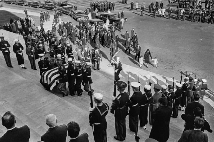Soldiers carry the flag-draped coffin of slain President John Fitzgerald Kennedy
