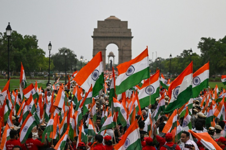 People waving Indian flags take part in a rally in New Delhi expressing solidarity with the armed forces