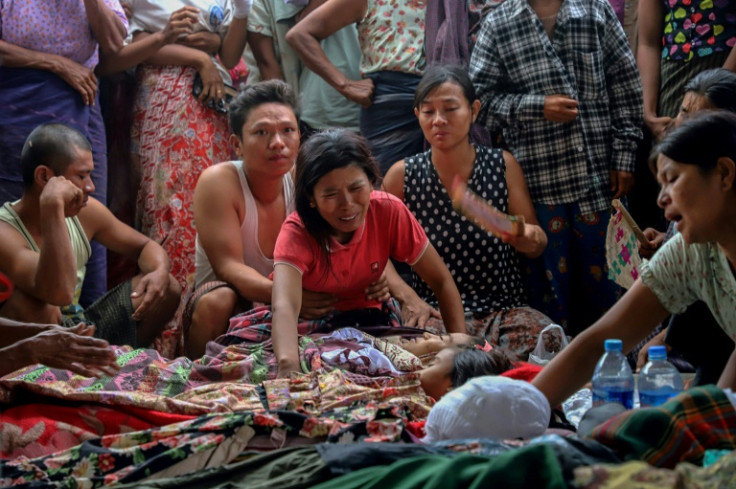 Mourners cry during a funeral of victims who were killed in an air strike in Sagaing region