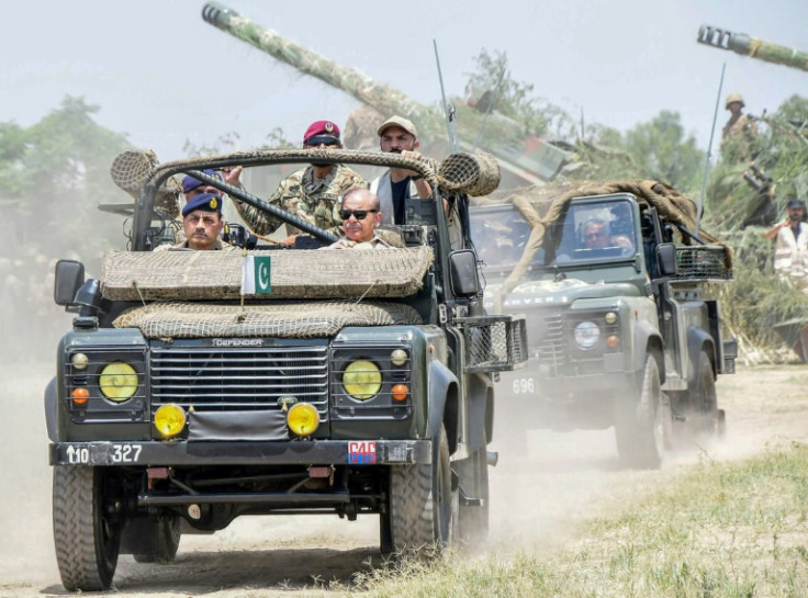 This handout photograph by Pakistan's Inter Services Public Relations shows Prime Minister Shehbaz Sharif (front, R) along with army chief General Asim Munir (front, L)